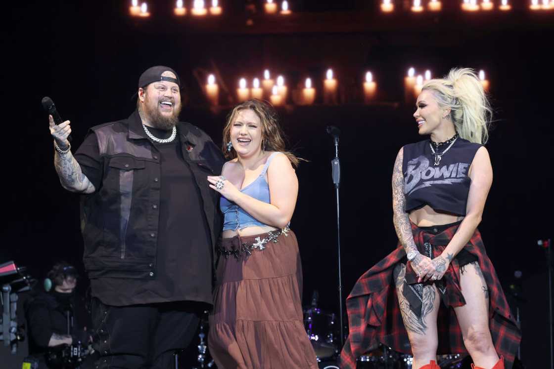 Jelly Roll and his wife and kid on stage in California