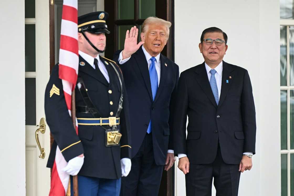 US President Donald Trump waves as he greets Japanese Prime Minister Shigeru Ishiba upon arrival outside the West Wing of the White House in Washington, DC, on February 7, 2025.