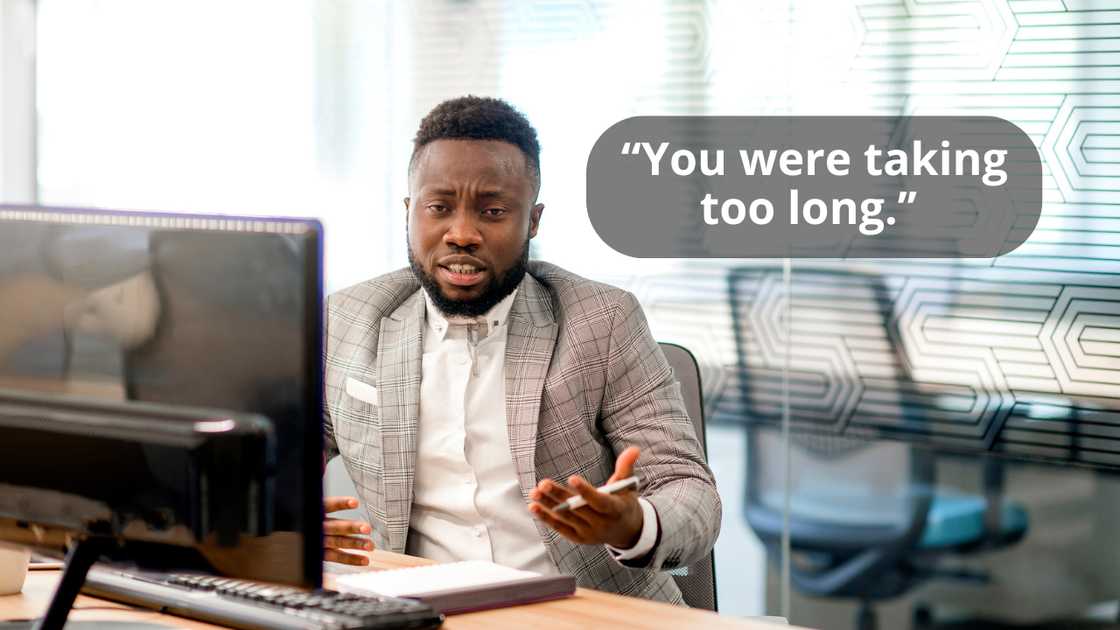 A businessman talking while looking at his computer