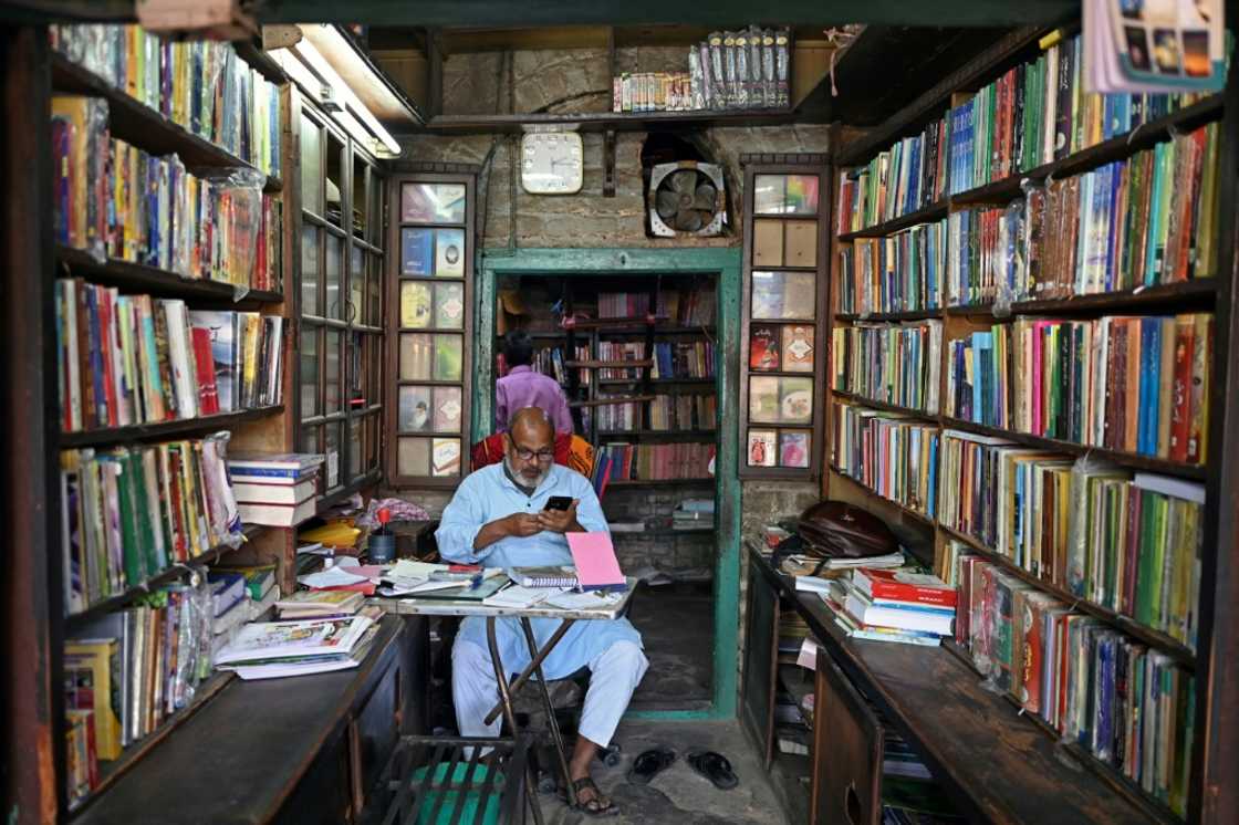 A bookseller waits for customers in the Urdu Bazar in Delhi