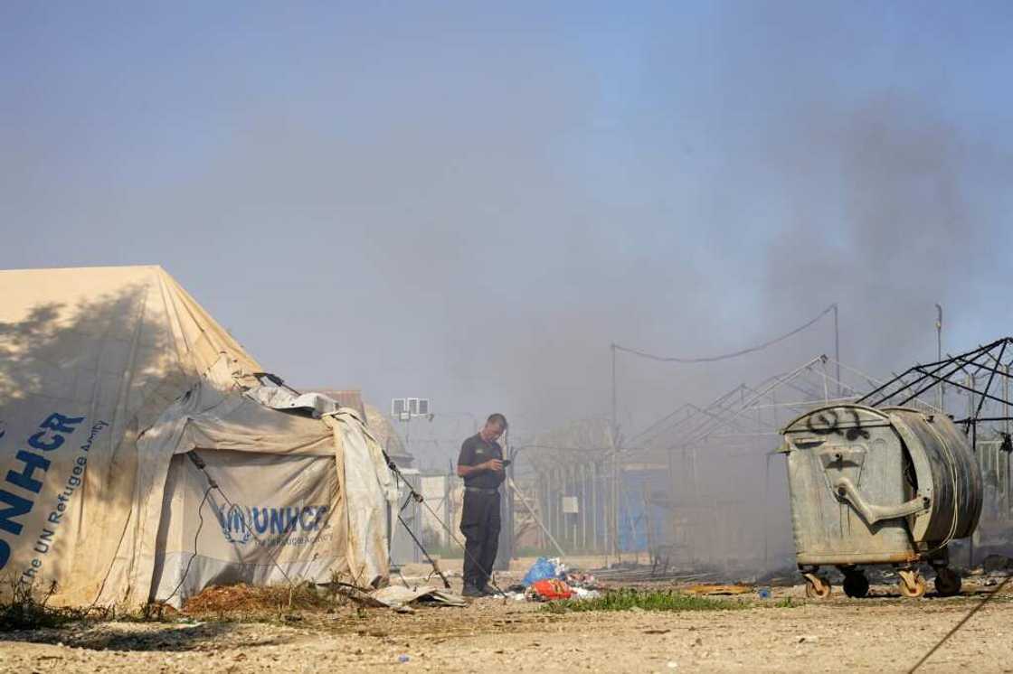 Smoke billows after clashes erputed in a camp for migrants the edge of the Cypriot capital Nicosia on Friday Smoke billows after clashes erputed in a camp for migrants the edge of the Cypriot capital Nicosia on Friday