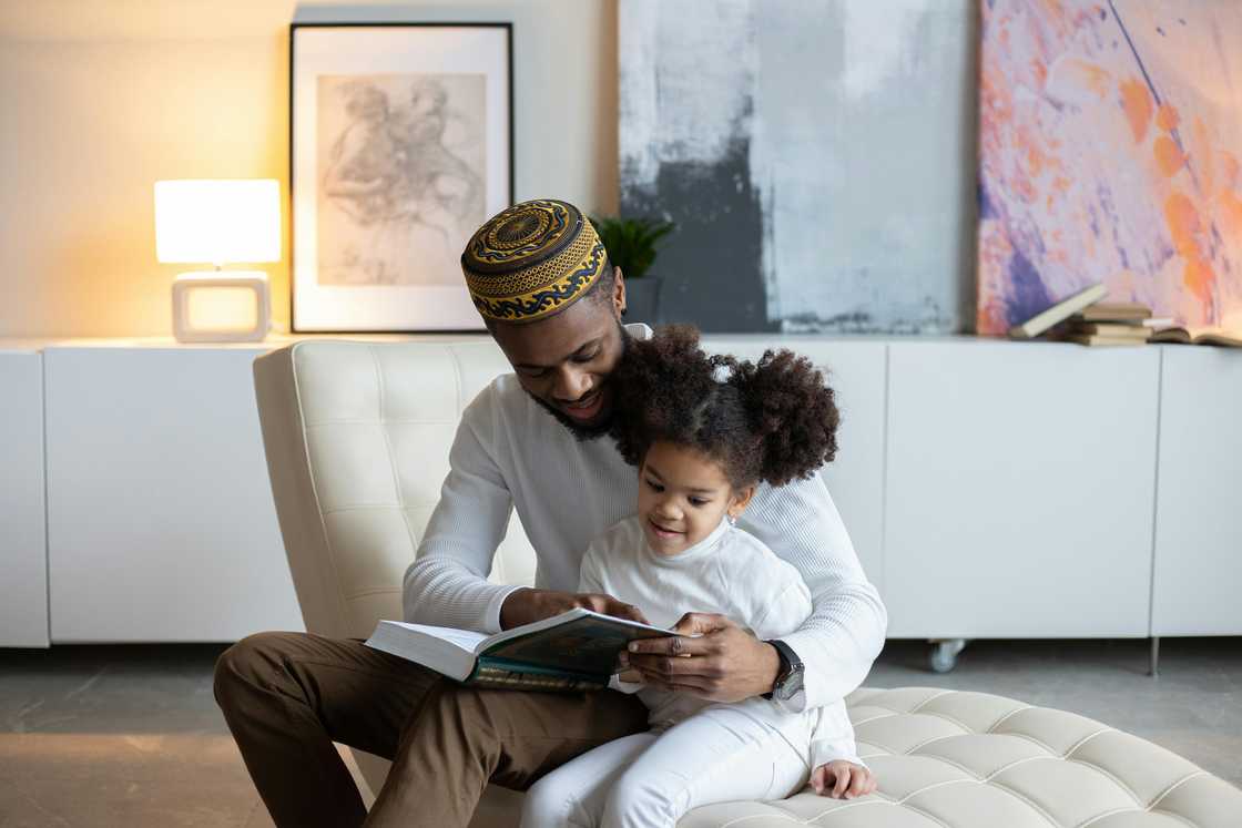 A father reading a book for his girl