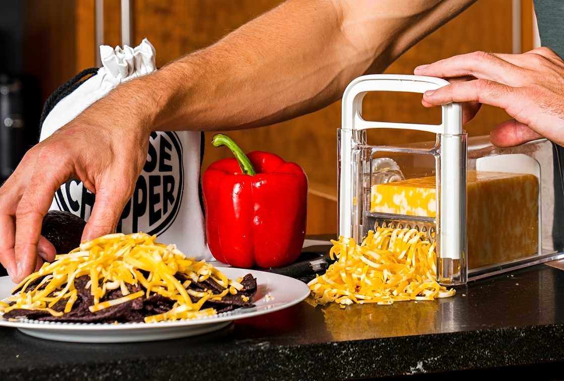 A person uses The Cheese Chopper A person uses The Cheese Chopper