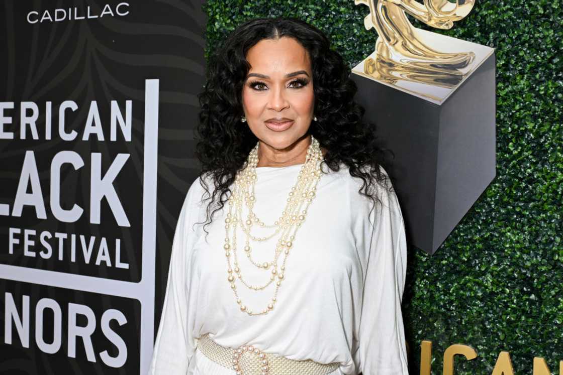 LisaRaye McCoy-Misick in a white ensemble and cream necklace and belt