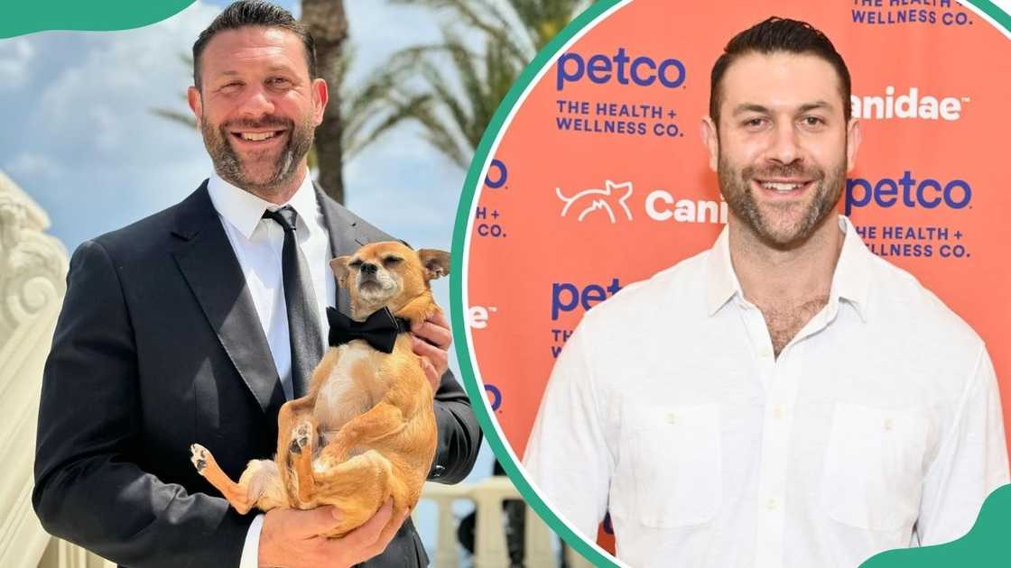 Lee Asher holding a dog and posing at an event Lee Asher holding a dog and posing at an event