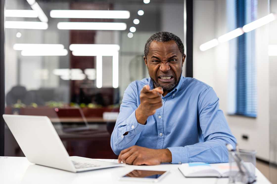 Angry man pointing fingers as he shouts