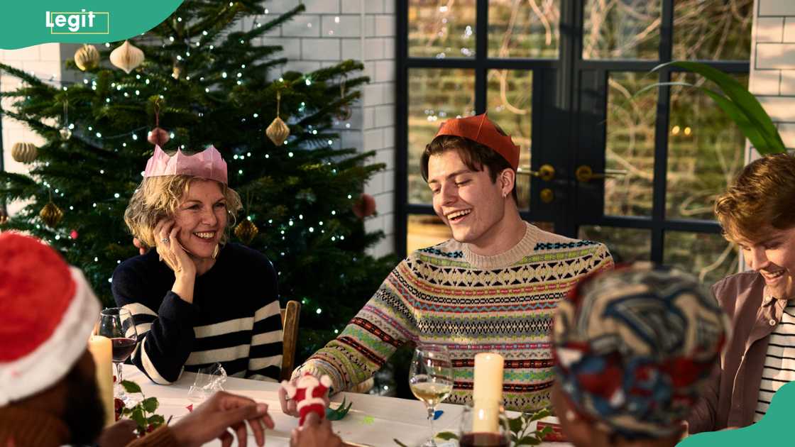 A group of friends having a fun moment around a table