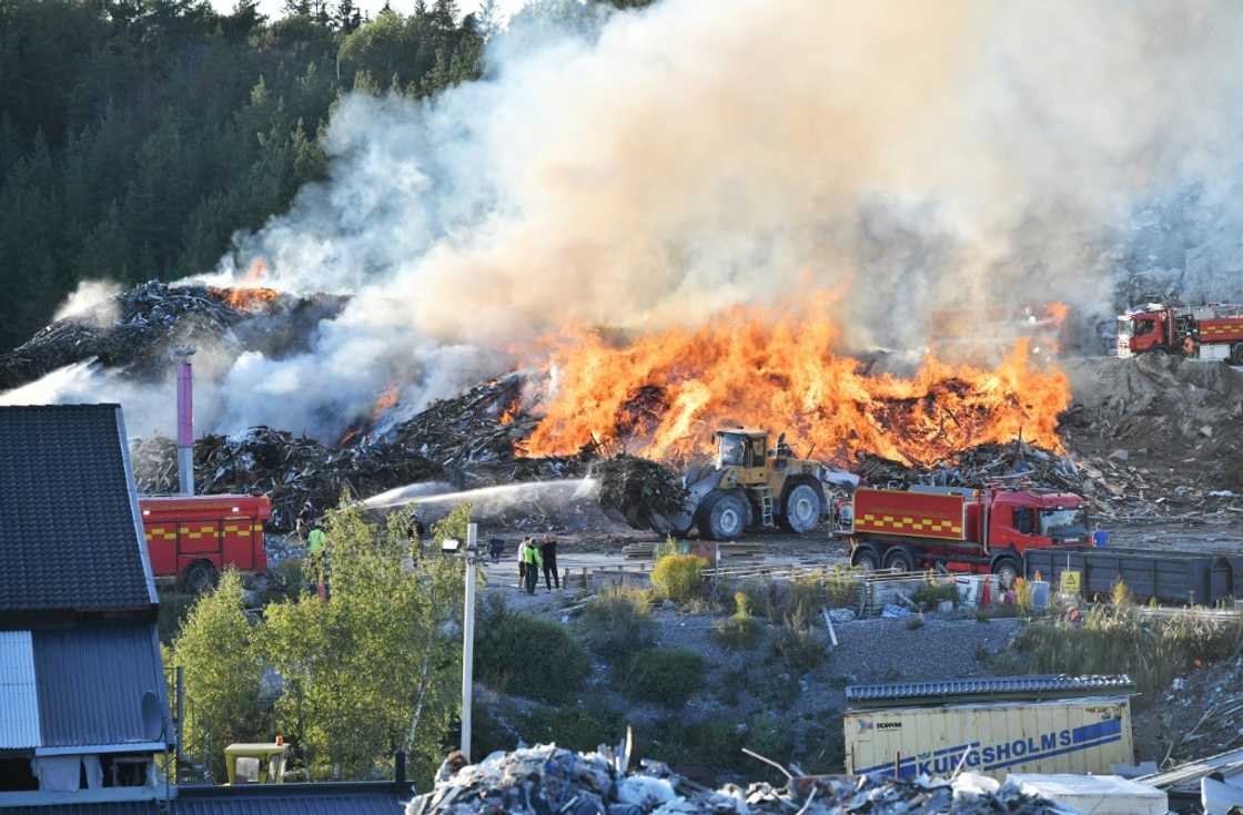 Firefighters tackle a blaze at a Think Pink landfill site at Botkyrka, south of Stockholm