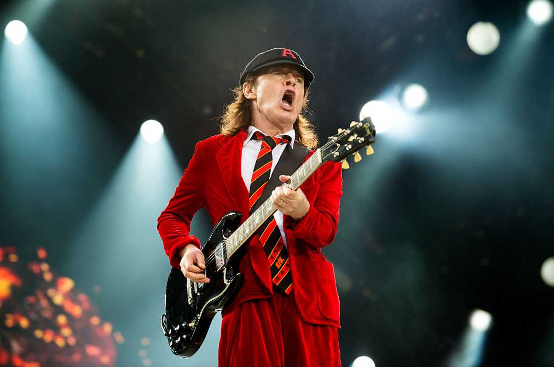 Angus Young performing on stage Angus Young performing on stage