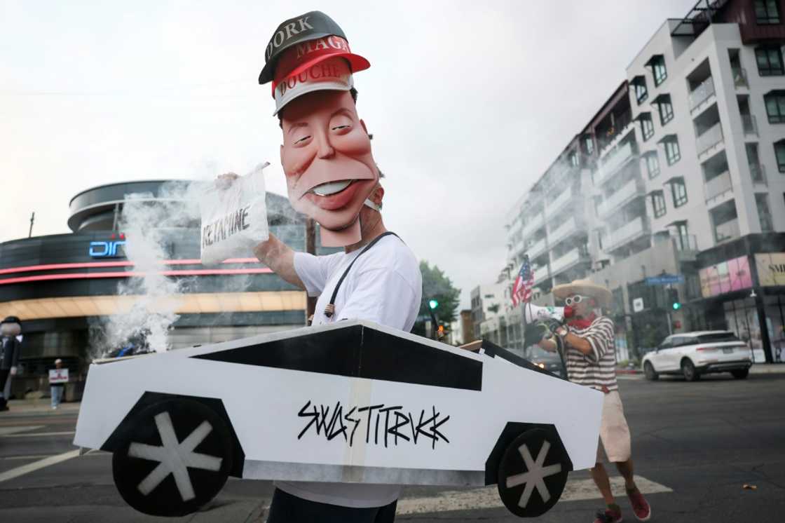 Demonstrators held signs during the 'Tyrant Diner' protest last month against Elon Musk outside of the Tesla Diner and Drive-In Restaurant and Supercharger in Los Angeles Demonstrators held signs during the 'Tyrant Diner' protest last month against Elon Musk outside of the Tesla Diner and Drive-In Restaurant and Supercharger in Los Angeles