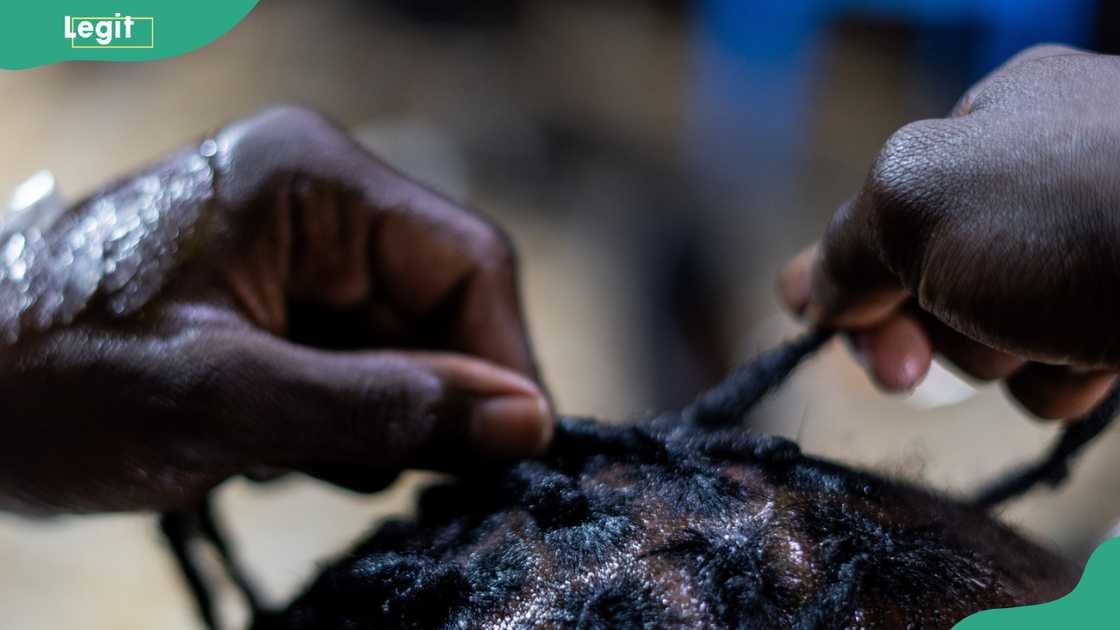 Someone plaiting another person's hair