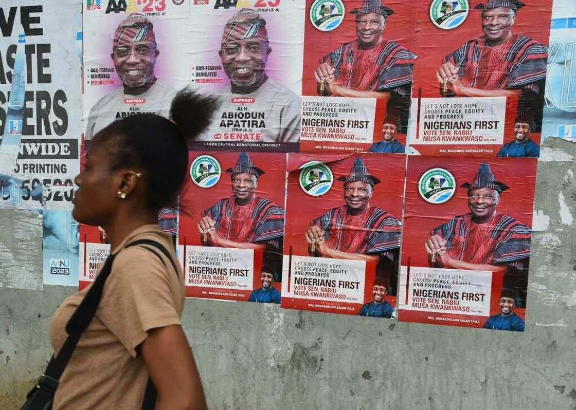 A woman walks past campaign posters of presidential aspirant of New Nigeria Peoples's Party (NNPP) Rabiu Kwankwaso. A woman walks past campaign posters of presidential aspirant of New Nigeria Peoples's Party (NNPP) Rabiu Kwankwaso.