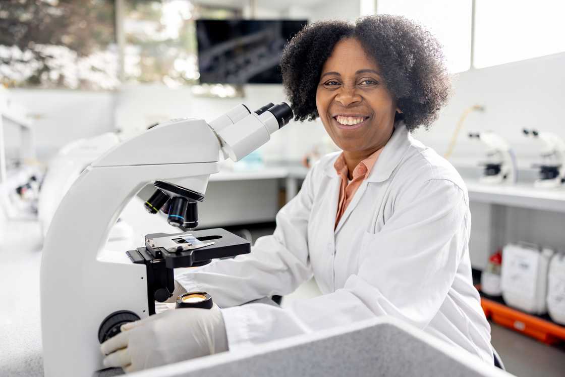 A female scientist at the laboratory using a microscope. A female scientist at the laboratory using a microscope.