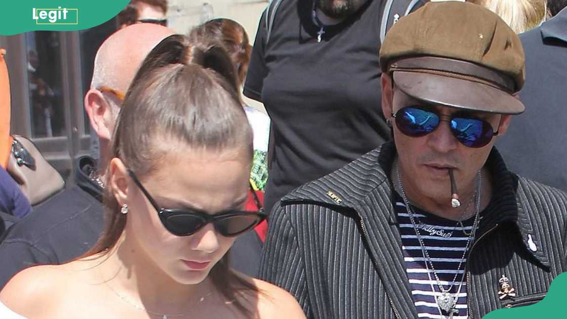 Polina Glen and Johnny Depp work together on a street