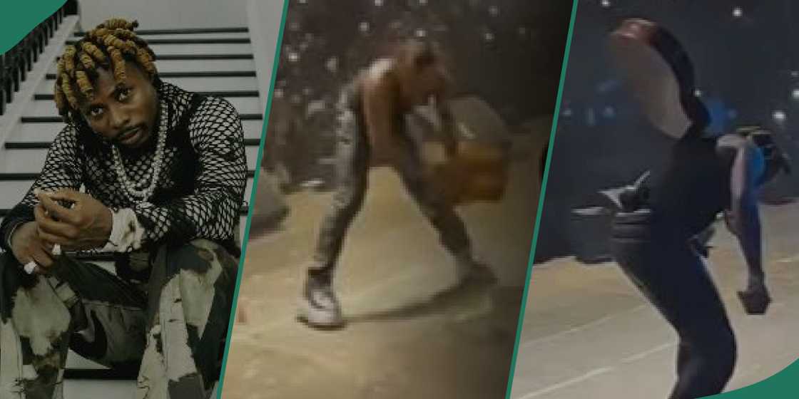 Singer Asake performing on stage before breaking his guitar Singer Asake performing on stage before breaking his guitar