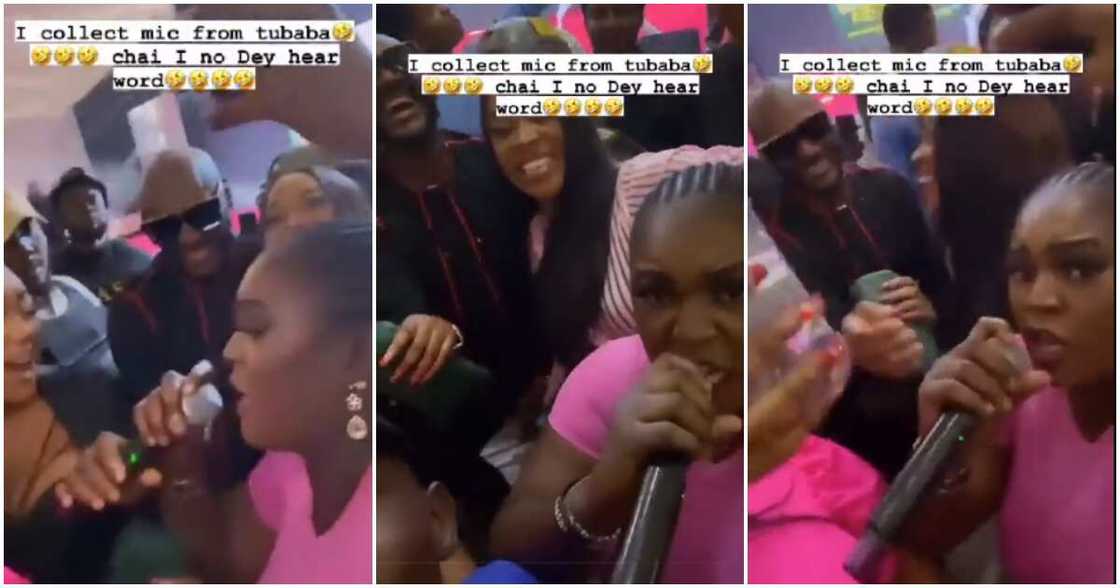 Woman collects microphone from 2baba during his performance. Woman collects microphone from 2baba during his performance.