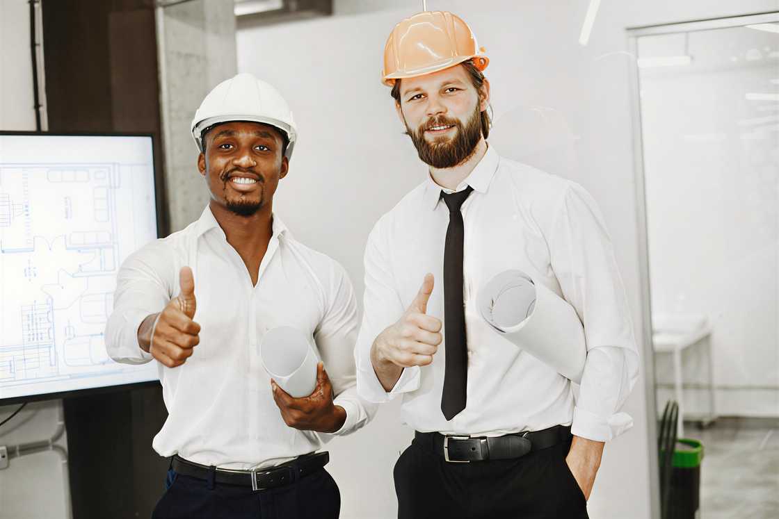 Two engineers showing a thumbs up