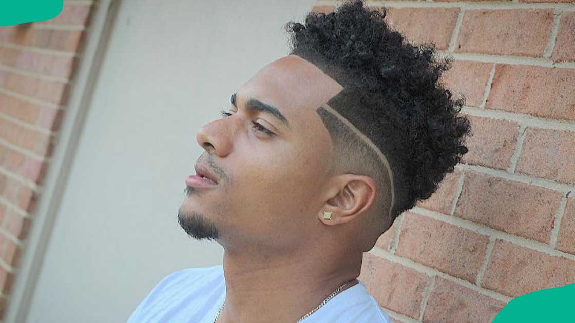 Medium high-top fade with design hairstyle for men Medium high-top fade with design hairstyle for men