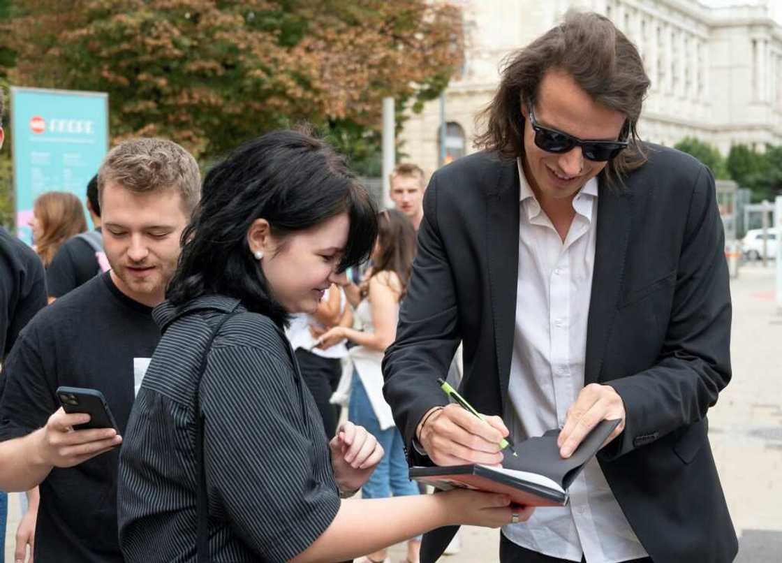 Beer party founder Dominik Wlazny signing autographs at a campaign event Beer party founder Dominik Wlazny signing autographs at a campaign event