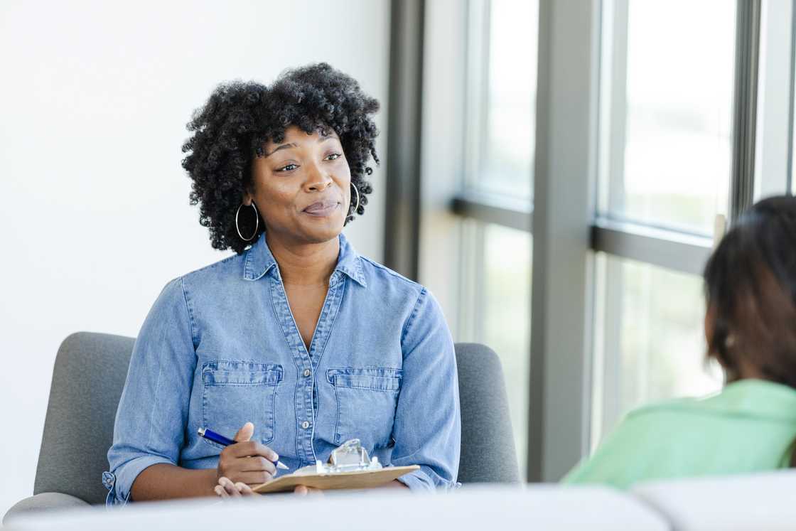 A counsellor takes notes during a counselling session