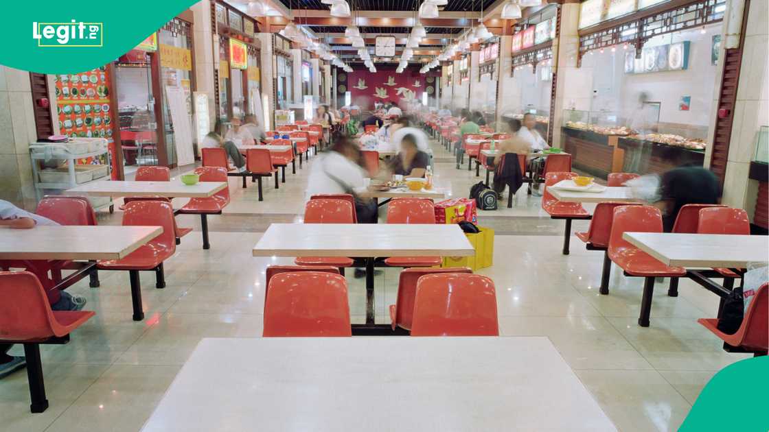 Interior of fast food restaurant, situated inside train station, busy with customers, long exposure Interior of fast food restaurant, situated inside train station, busy with customers, long exposure