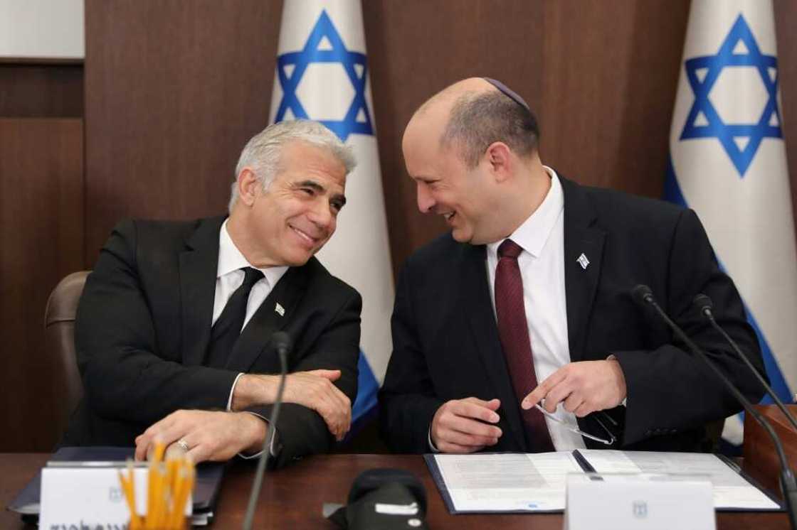 Israeli Prime Minister Naftali Bennett (R) speaks with Foreign Minister Yair Lapid (L) during a cabinet meeting in Jerusalem, Israeli Prime Minister Naftali Bennett (R) speaks with Foreign Minister Yair Lapid (L) during a cabinet meeting in Jerusalem,