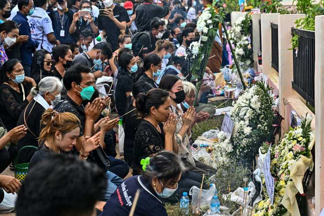 Families wept as they knelt outside the nursery in a ceremony to help release their children's souls