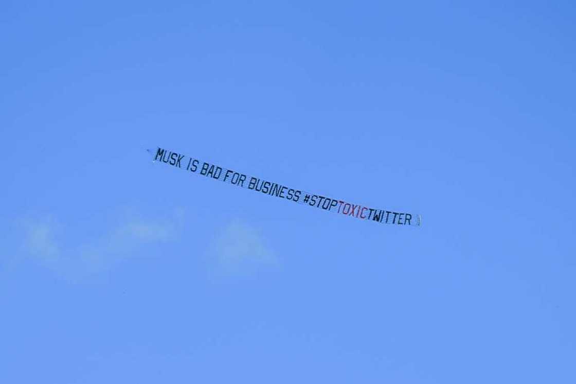 A banner reading, "Musk is Bad for Business #StopToxicTwitter" is flown over a conference venue in Miami, Florida where the Twitter CEO made a keynote address