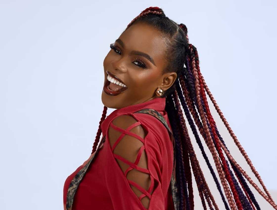 Mercedes smiles in a pose during a photoshoot.