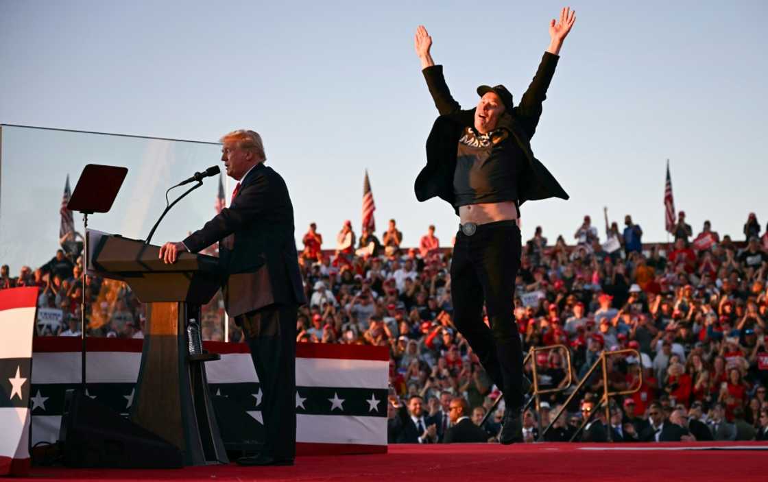 Tesla and SpaceX CEO Elon Musk exults during a Donald Trump rally in Pennsylvania in October 2024 -- the pair have become fast friends