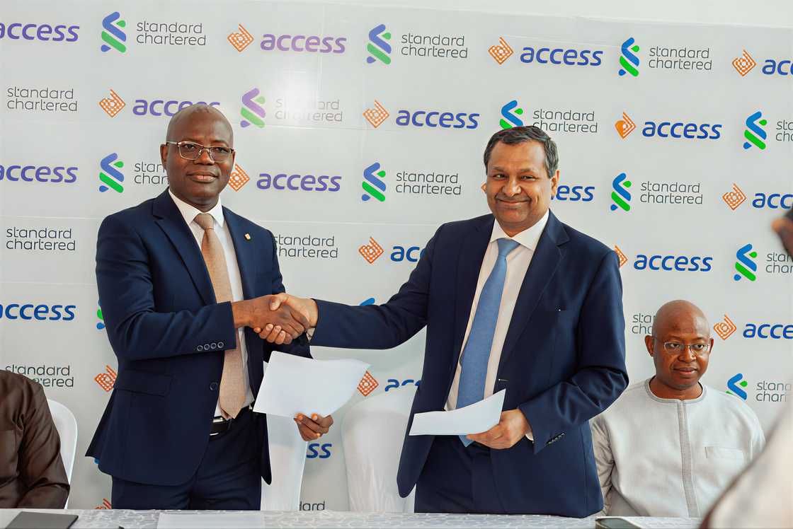 Access Bank manager handing documents to an investor Access Bank manager handing documents to an investor