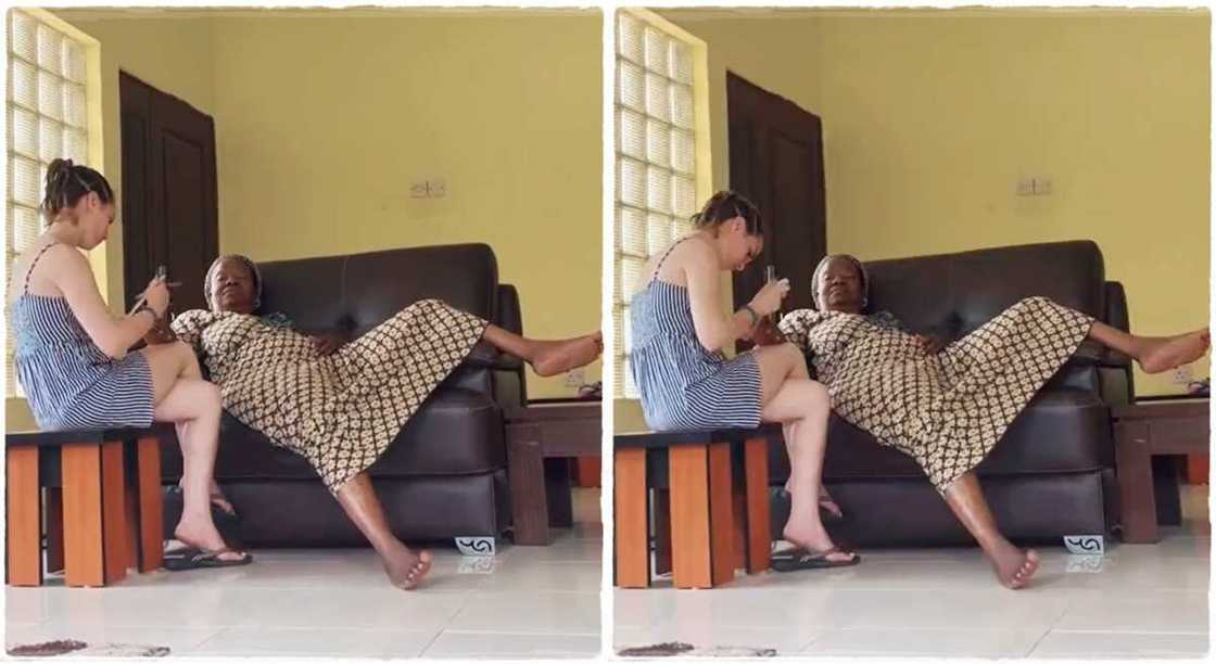 White woman cleans mother-in-law's nails. White woman cleans mother-in-law's nails.