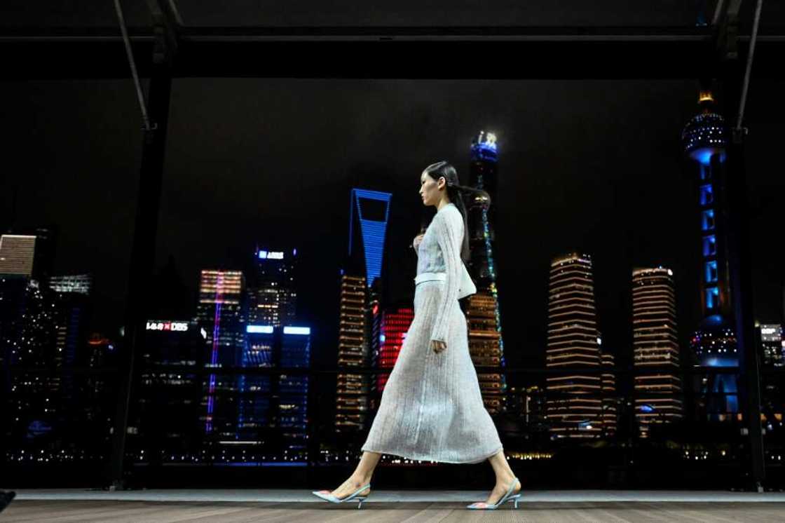 Against Shanghai's glittering river skyline, Kenzo-clad models strutted down a breezy open-air runway for the French fashion brand's first-ever show in China Against Shanghai's glittering river skyline, Kenzo-clad models strutted down a breezy open-air runway for the French fashion brand's first-ever show in China