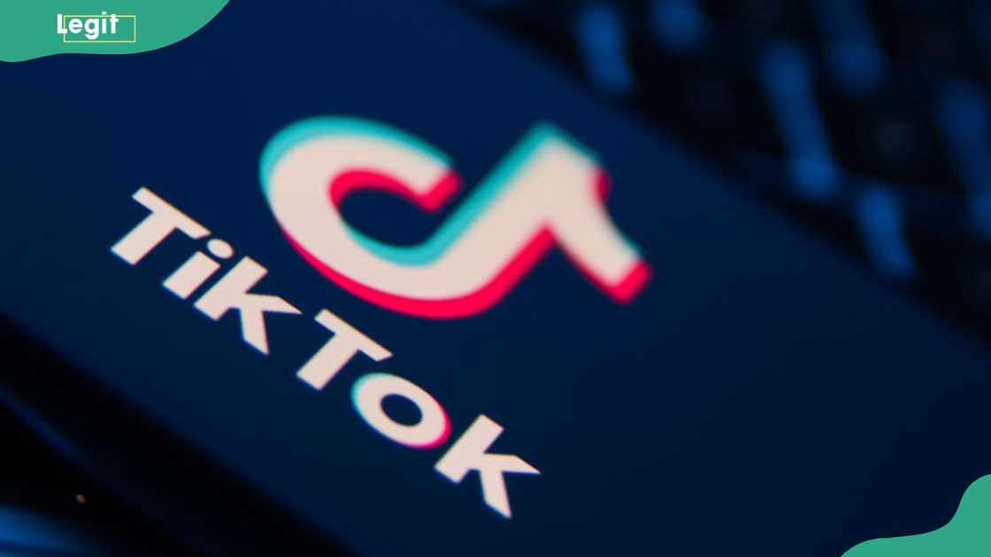 TikTok logo displayed on a black surface TikTok logo displayed on a black surface