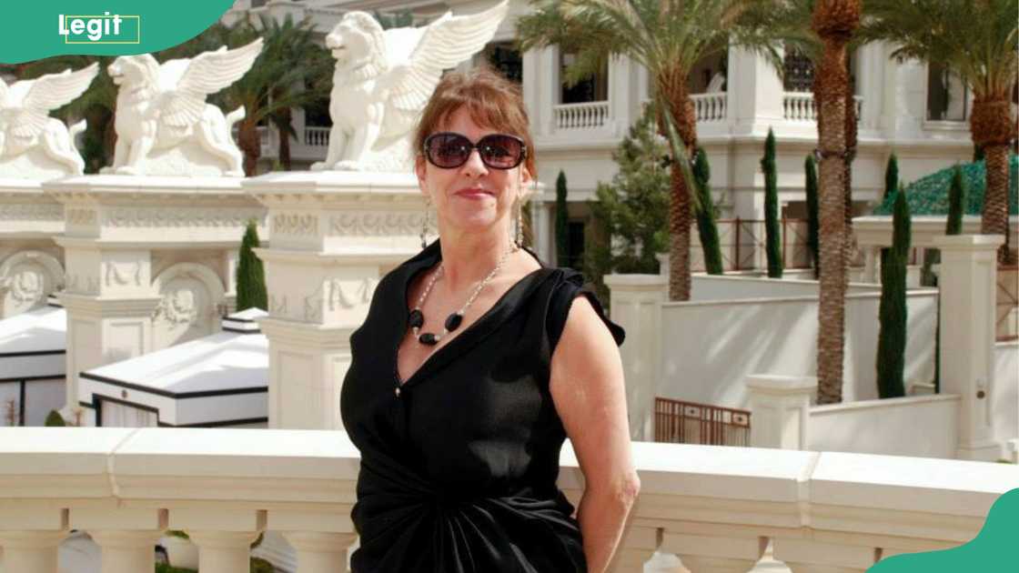 Ghislaine Dion posing while leaning on a white balcony Ghislaine Dion posing while leaning on a white balcony