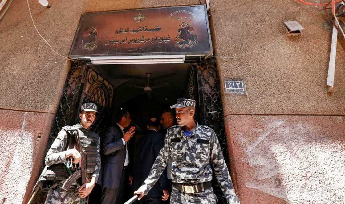 Egyptian police outside the charred Abu Sifin church located in the densely populated Imbaba neighbourhood west of the Nile river on August 14, 2022 Egyptian police outside the charred Abu Sifin church located in the densely populated Imbaba neighbourhood west of the Nile river on August 14, 2022