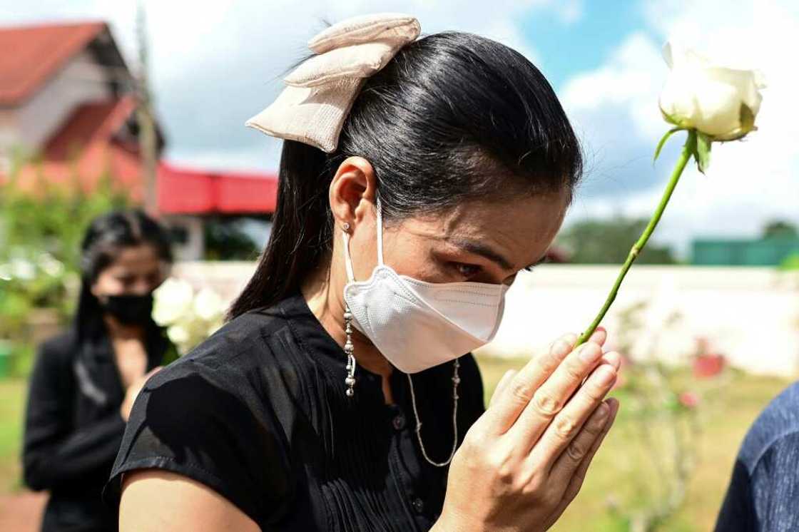 Mourners lay single white roses on the steps of the Thai nursery where nearly two dozen children were murdered Mourners lay single white roses on the steps of the Thai nursery where nearly two dozen children were murdered