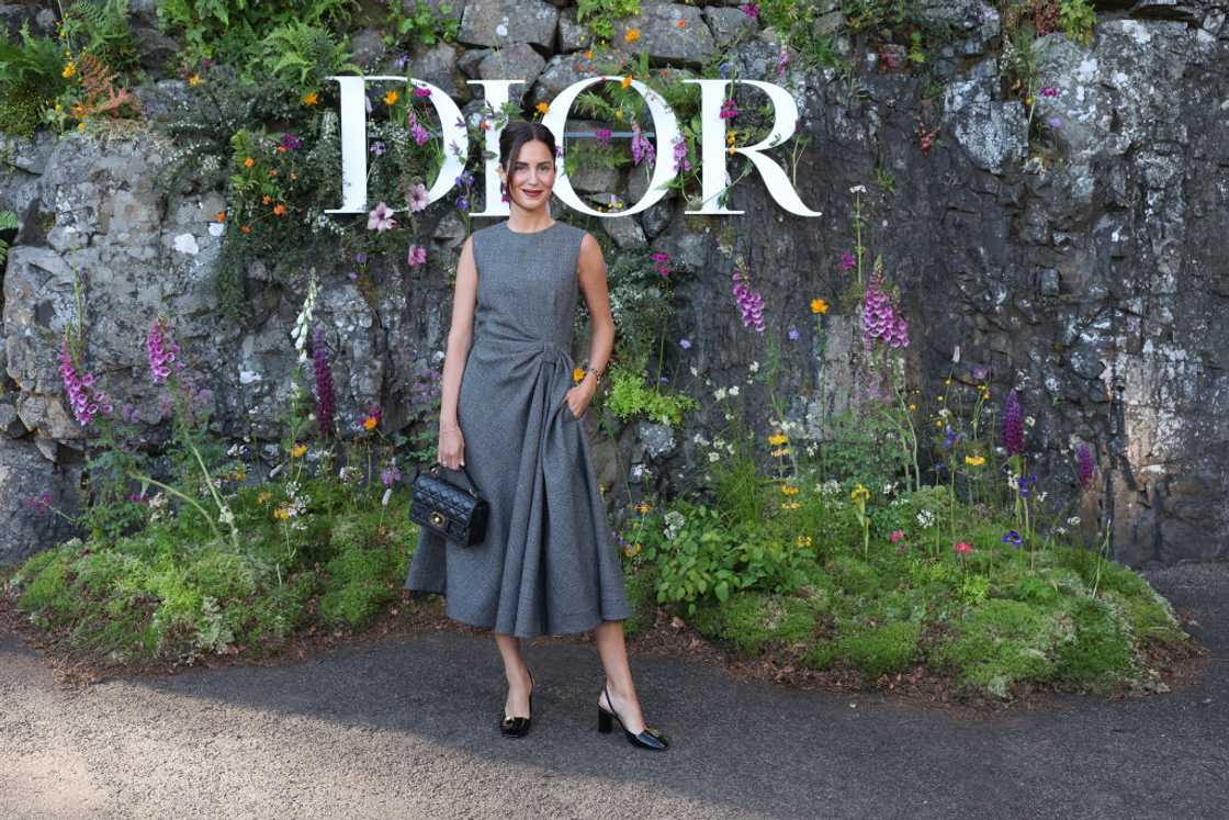 Gala Gonzalez in a grey dress and black bag at the Dior Cruise 2025 at Drummond Castle Gala Gonzalez in a grey dress and black bag at the Dior Cruise 2025 at Drummond Castle