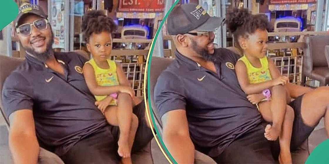 Mum expresses jealousy as little daughter sits on dad's lap Mum expresses jealousy as little daughter sits on dad's lap