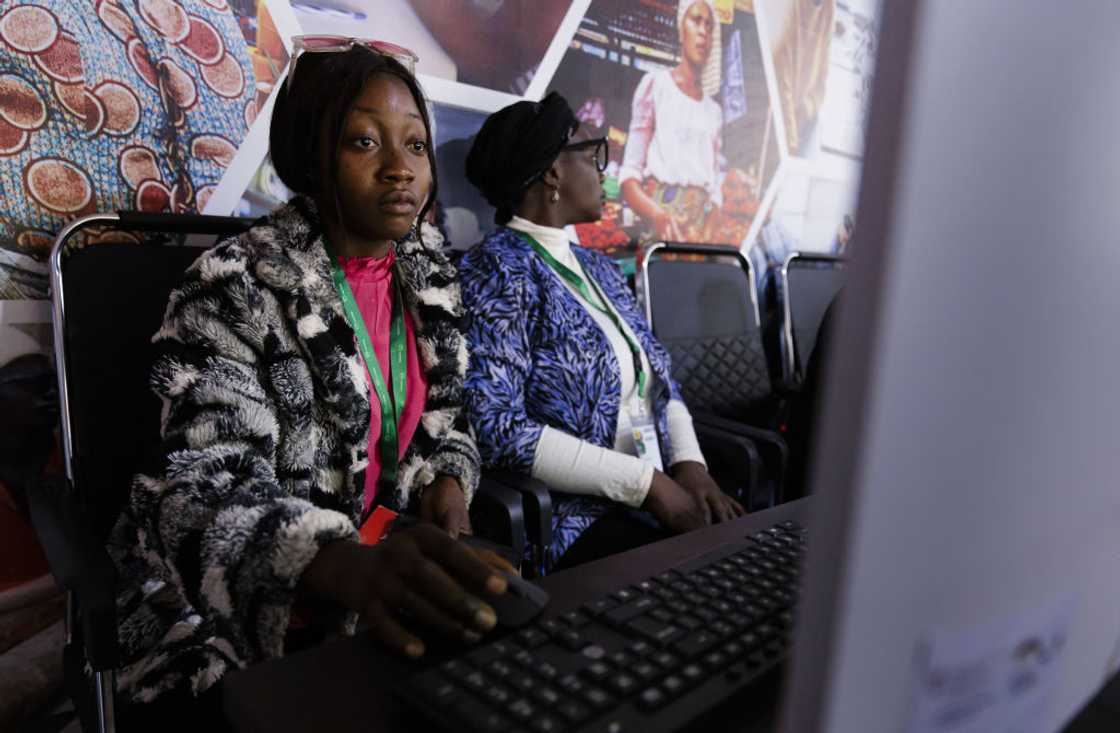 Women seated at desks working on computers at a vocational training centre in Jos, Nigeria, 2024