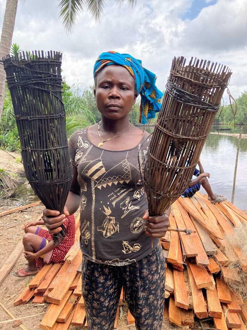 Esther shows the effect of oil spill on her fishing cage