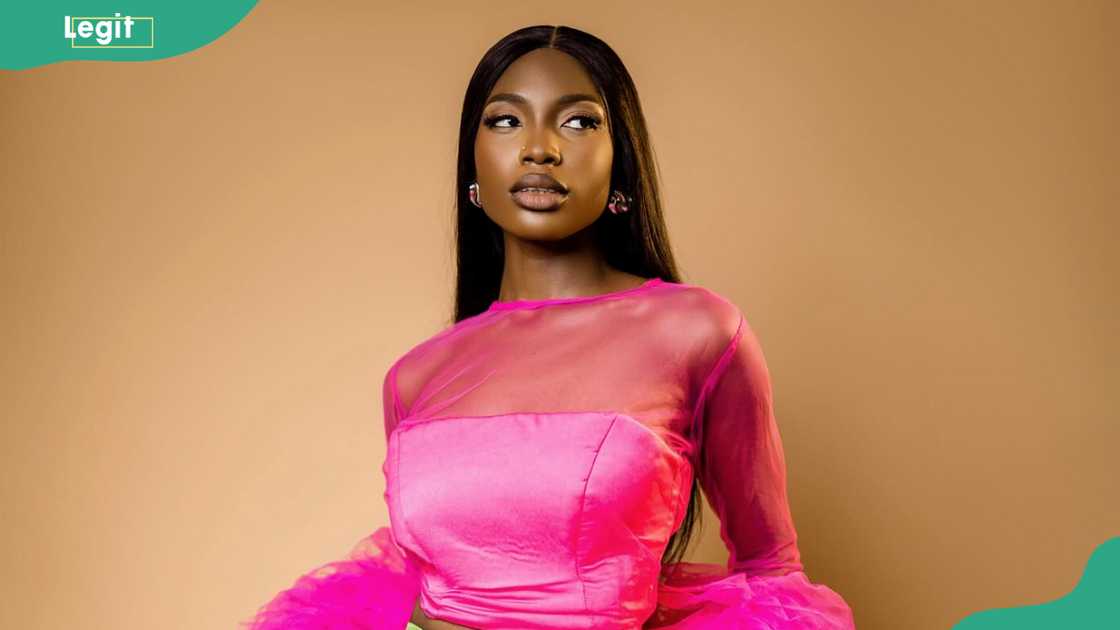 Joanna from BBNaija posing for a photo in a pink dress