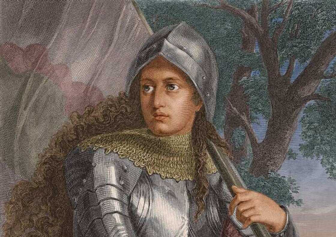 A portrait of Joan of Arc carrying a sword and a flag on the battlefield A portrait of Joan of Arc carrying a sword and a flag on the battlefield