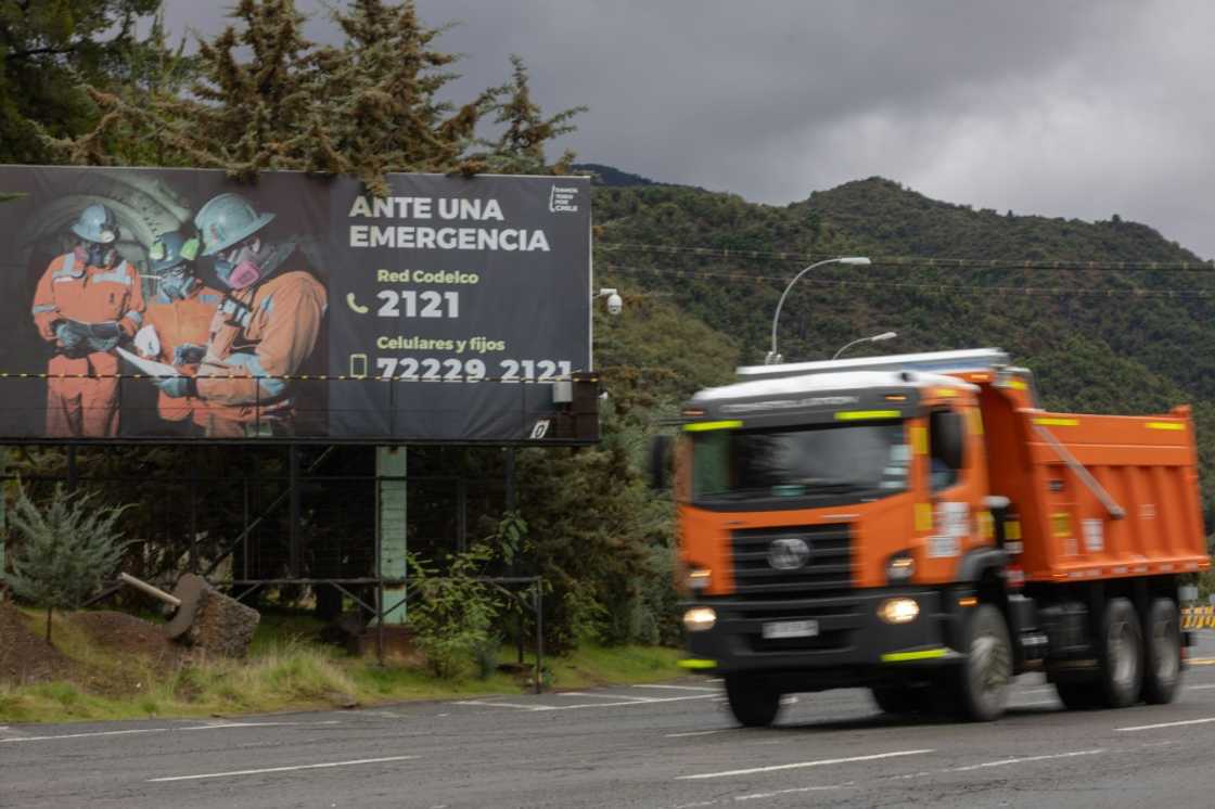A truck drives past an emergency sign at the entrance to the El Teniente mine near Rancagua, Chile, on August 1, 2025 A truck drives past an emergency sign at the entrance to the El Teniente mine near Rancagua, Chile, on August 1, 2025