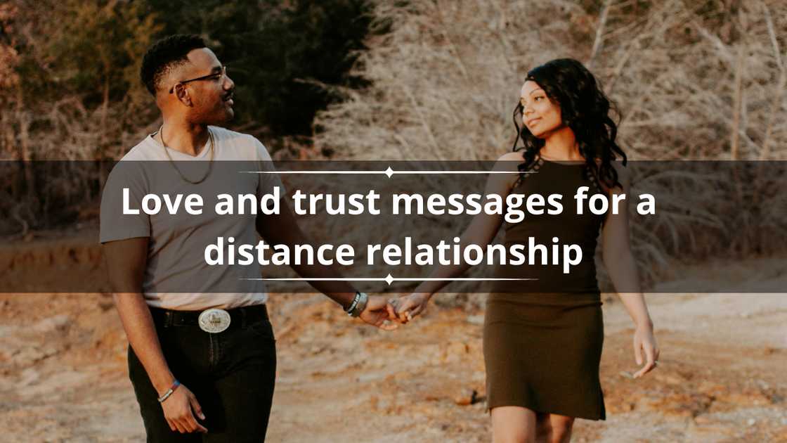 A happy man and woman are looking into each other's eyes as they walk down a dusty path