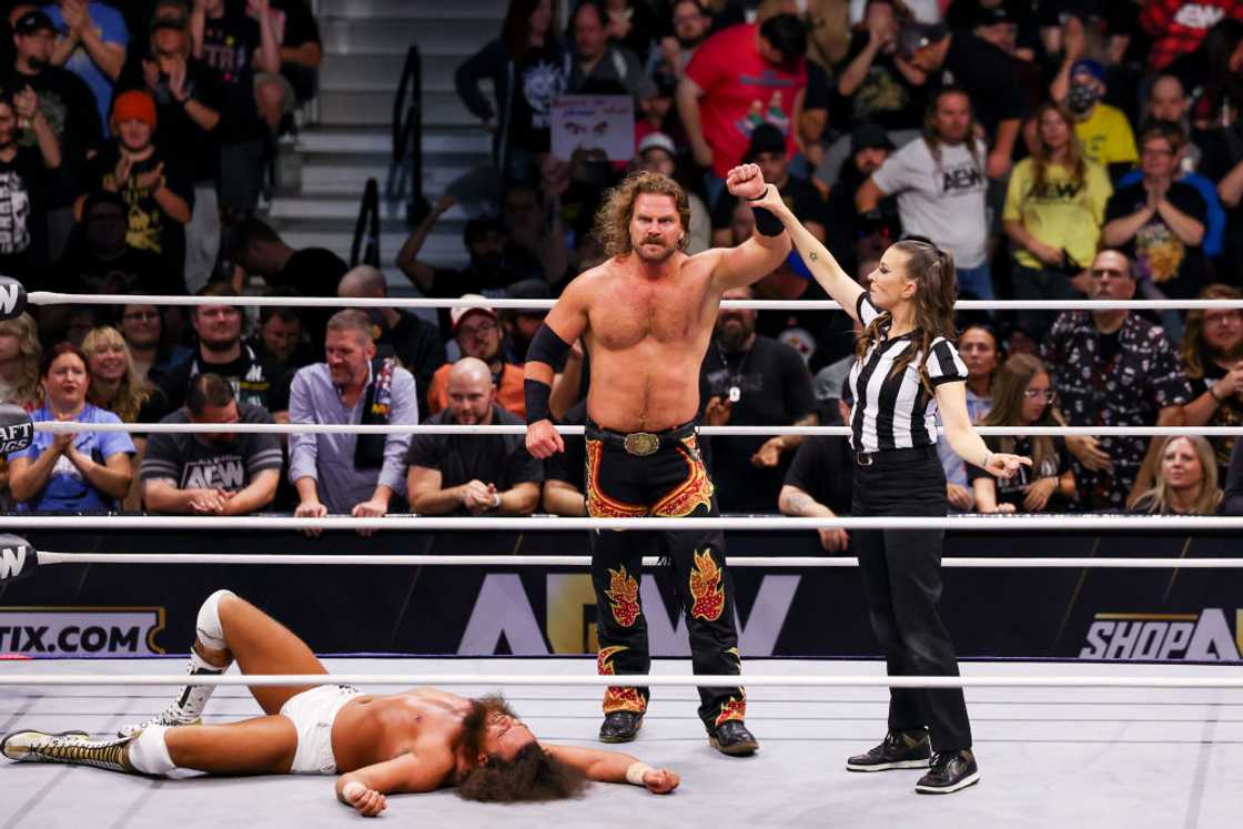 Referee Aubrey Edwards raises the hand of Hangman Adam Page