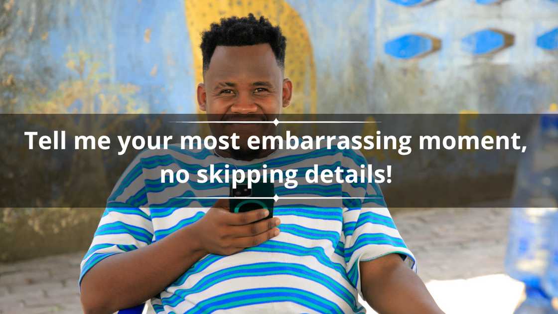 A man in a blue and white striped tee is smiling as he uses a mobile phone A man in a blue and white striped tee is smiling as he uses a mobile phone