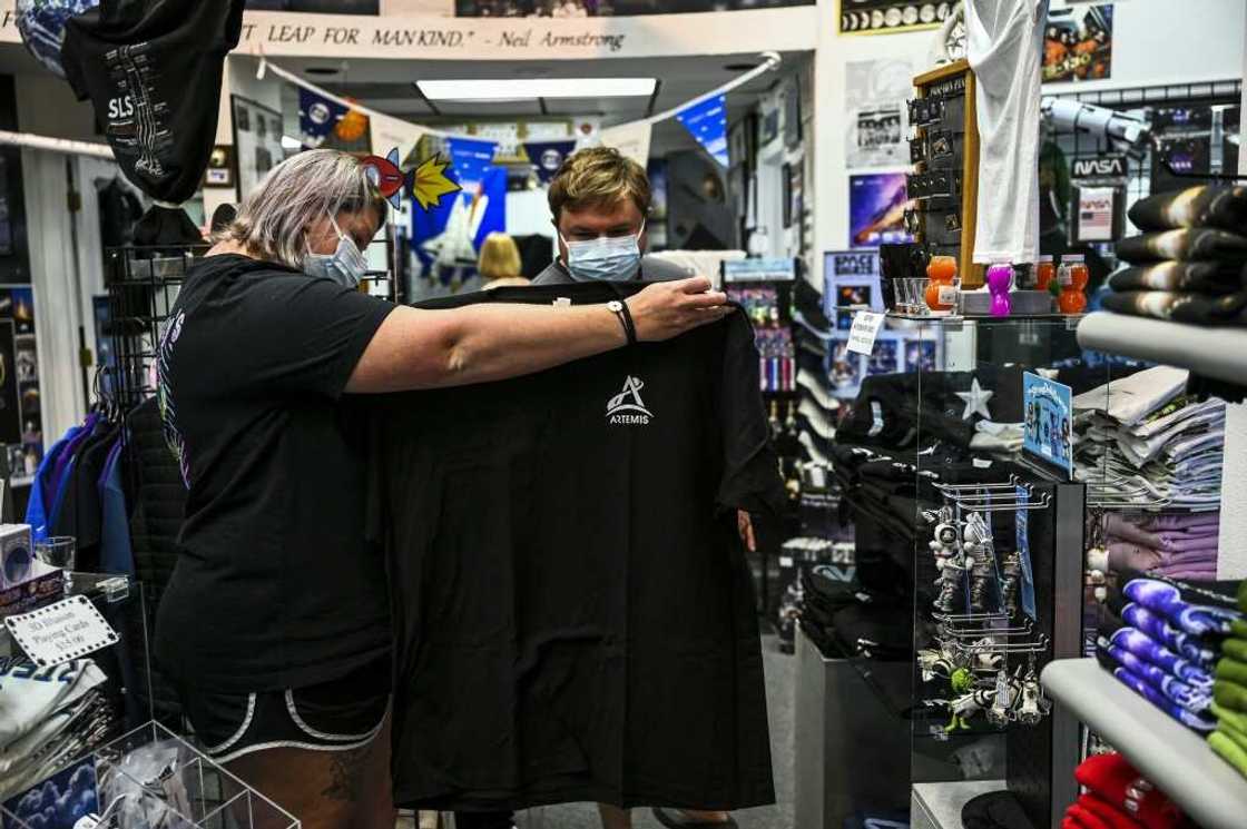 Tourists at a space t-shirt store shop near the Kennedy Space Center in Florida, August 27, 2022 Tourists at a space t-shirt store shop near the Kennedy Space Center in Florida, August 27, 2022