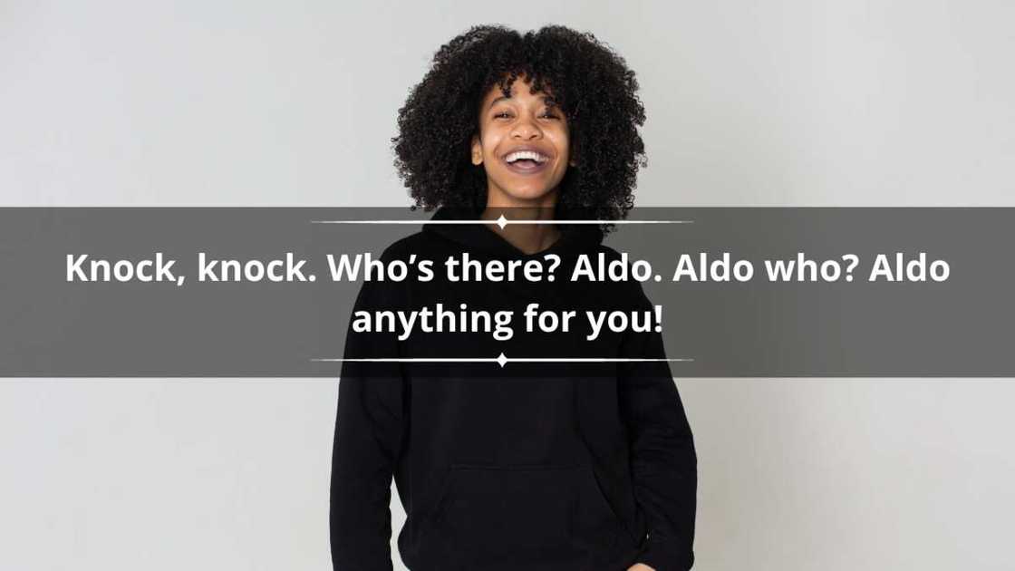 A young woman in a black outfit is pictured as she laughs. A young woman in a black outfit is pictured as she laughs.