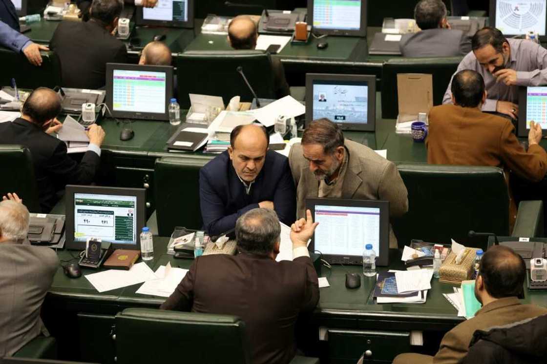 Iranian MPs attend the parliamentary session